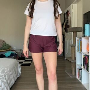 Under Armour maroon and black athletic shorts with elastic waistband